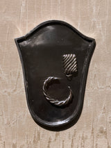 Umbria Tray, a crest-shaped cast-metal catchall in brass or aluminum