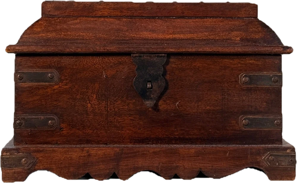 A dark wooden box with iron straps and a scalloped base