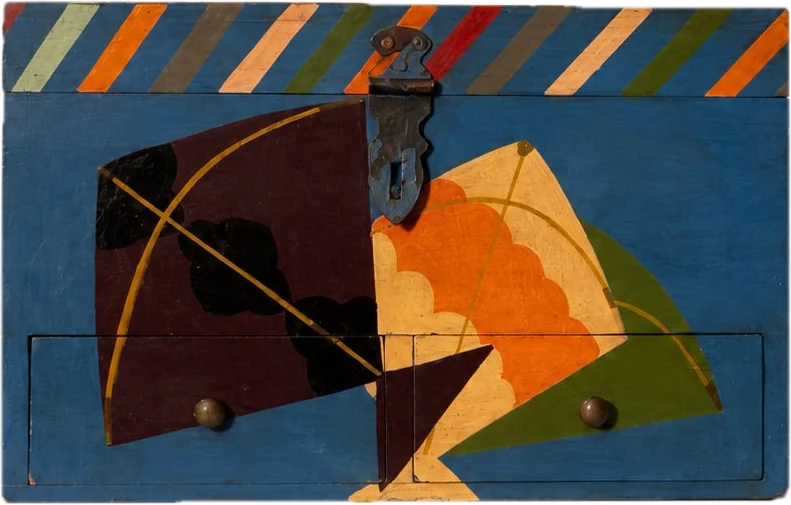A blue box painted with kites over two drawers