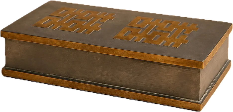 A gray metal box with a brass maze inlaid in its lid