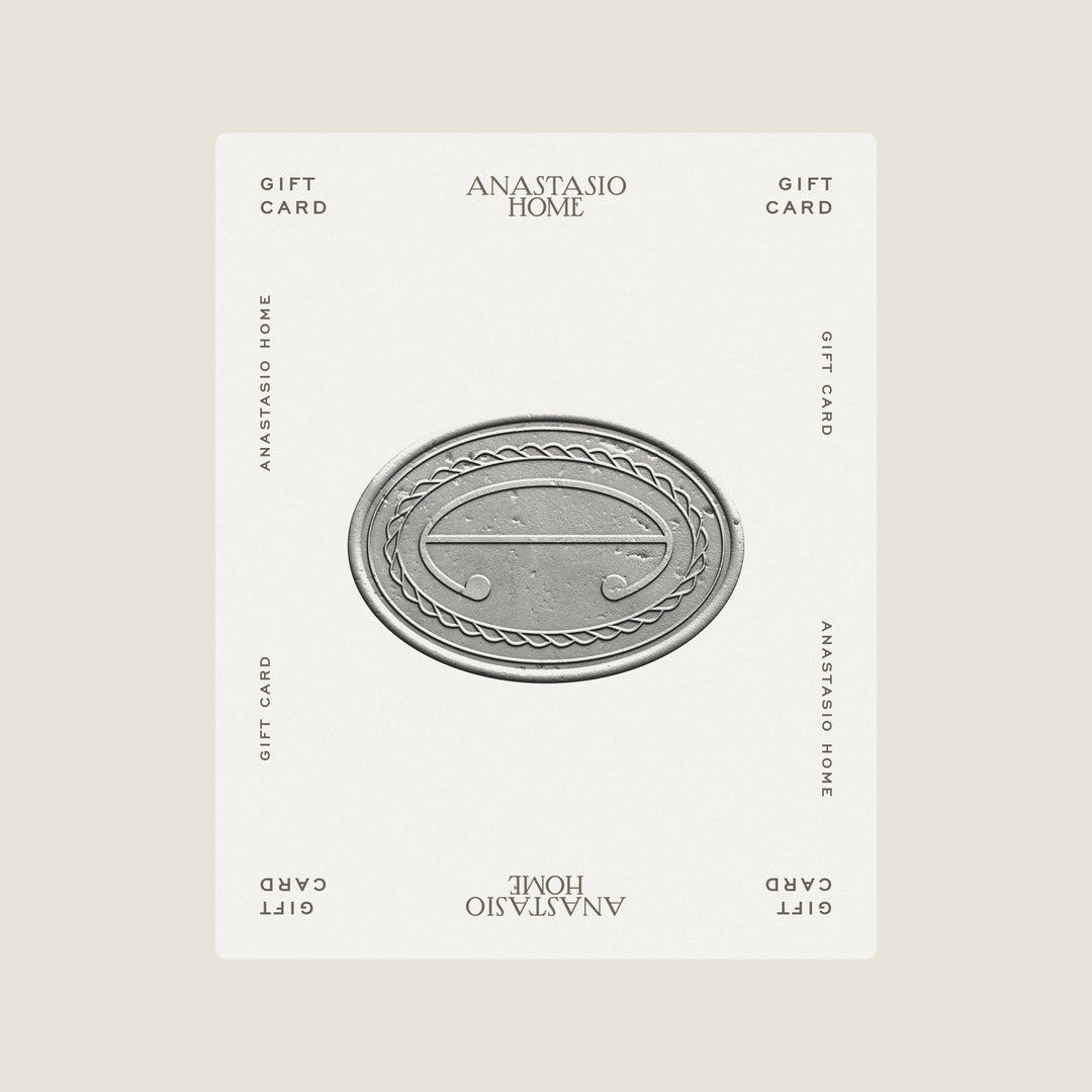Anastasio Home gift card: an Ivory card with the rope emblem struck in a silver medallion, ANASTASIO HOME and GIFT CARD at both ends like a playing card