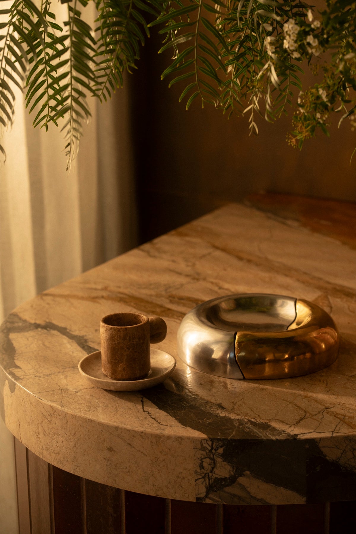 The Fusion Bowl and a marble cup on the marble bar under trailing ferns